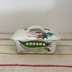 A vintage  china lidded butter dish with a hand painted radish and pea  design
