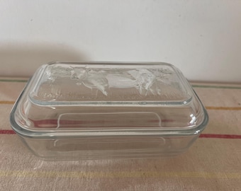 A pristine  original French retro clear glass  lidded butter dish with a cow design pressed on the lid