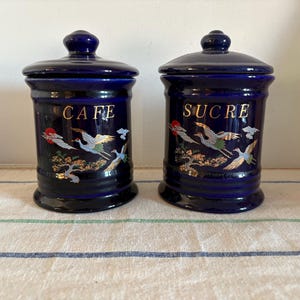 A rare set of two  cobalt blue china  lidded canister pots with a gold flying bird oriental decor Cafe and Sucre