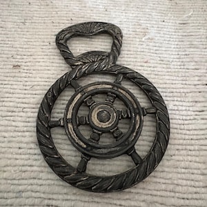 An original Frenchvintage nautical, ships wheel metal bronze bottle opener