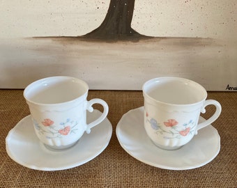 An usual pair of taller milky white glass 1970s vintage  Arcopal floral 15  tea or coffee cups with saucers