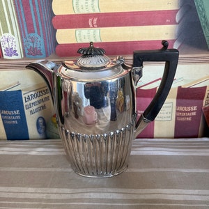 A  antique Victorian Silver Batchelors coffee pot with an ebonised  wooden handle and finial and  hinged lid