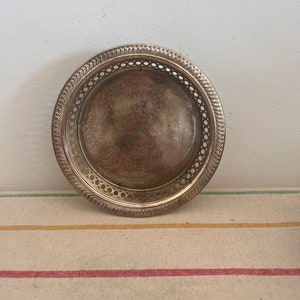 A retro decorative  silver plated wine or champagne table coaster