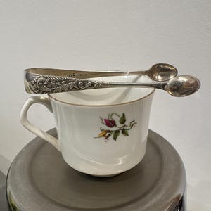 A lovely ornate silver plated EP A1  sugar tongs from the early 1900s