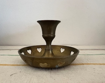 A pretty brass heart design  vintage candlestick holder  with drip saucer