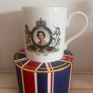 A Royal bone china mug by Grove China commemorate The Queens 1952- 2002 Golden Jubilee