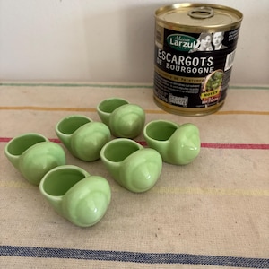 A traditional set of 6  lime green French vintage oven proof individual stoneware snail dishes