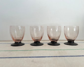 A gorgeous set of four French vintage Rosaline pinky peach port liqueur glasses with black base