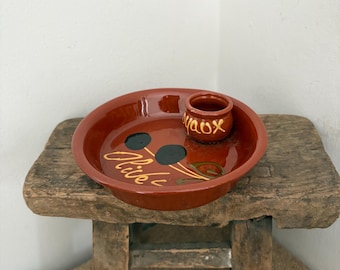 A  French an vintage  rustic glazed terracotta clay dish for serving olives with drinks with a place for sticks or stones