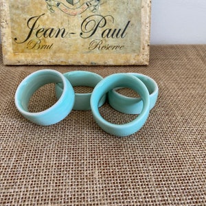 May include: Set of four light blue ceramic napkin rings.