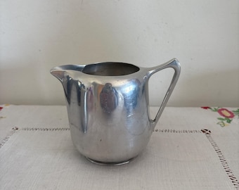 A gorgeous Picquot Ware English  polished solid aluminium 1950's milk jug creamer with handle