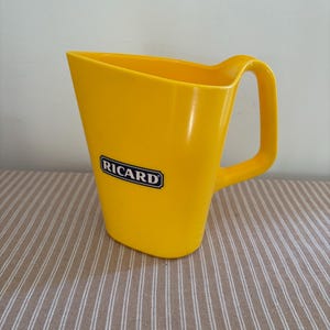 A French vintage Ricard brand promotional  yellow plastic water jug to  serve pastis in an authentic way