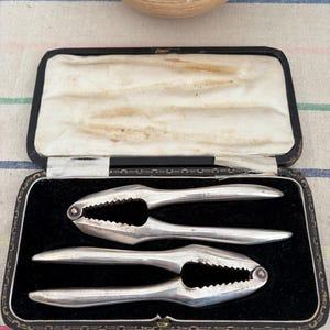 A lovely unusual boxed pair of  silver plated tactile heavy duty antique nut or seafood  crackers
