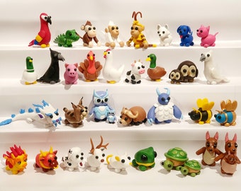 Figurines Adoptez-moi pour animaux de compagnie : perroquet, reine des abeilles, rage du froid, hibou des neiges, hibou, chat rose, chien bleu, dalmatien, kangourou, lion gardien, bœuf lunaire, tortue