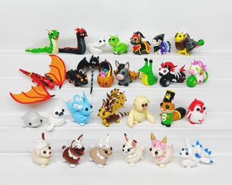 May include: A collection of 24 handmade polymer clay figurines, featuring a variety of animals, creatures, and characters. The figurines are brightly colored and detailed, with a whimsical and playful style.
