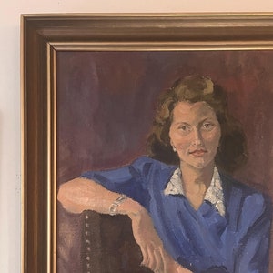 May include: A framed oil painting of a woman in a blue dress, sitting in a chair with her arm resting on the back. The background is a dark purple.