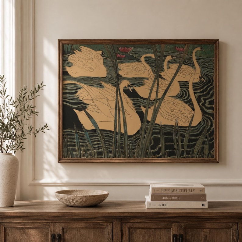 May include: A rectangular framed wall art print featuring a stylized illustration of several beige swans swimming in dark water among tall green reeds. The artwork displays a repeating pattern of birds with long necks and detailed feathers in a pond setting.