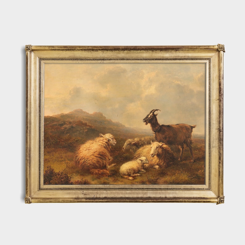 May include: A framed oil painting depicting a brown goat and several sheep in a grassy field. The scene is set against a backdrop of rolling hills and a cloudy sky.