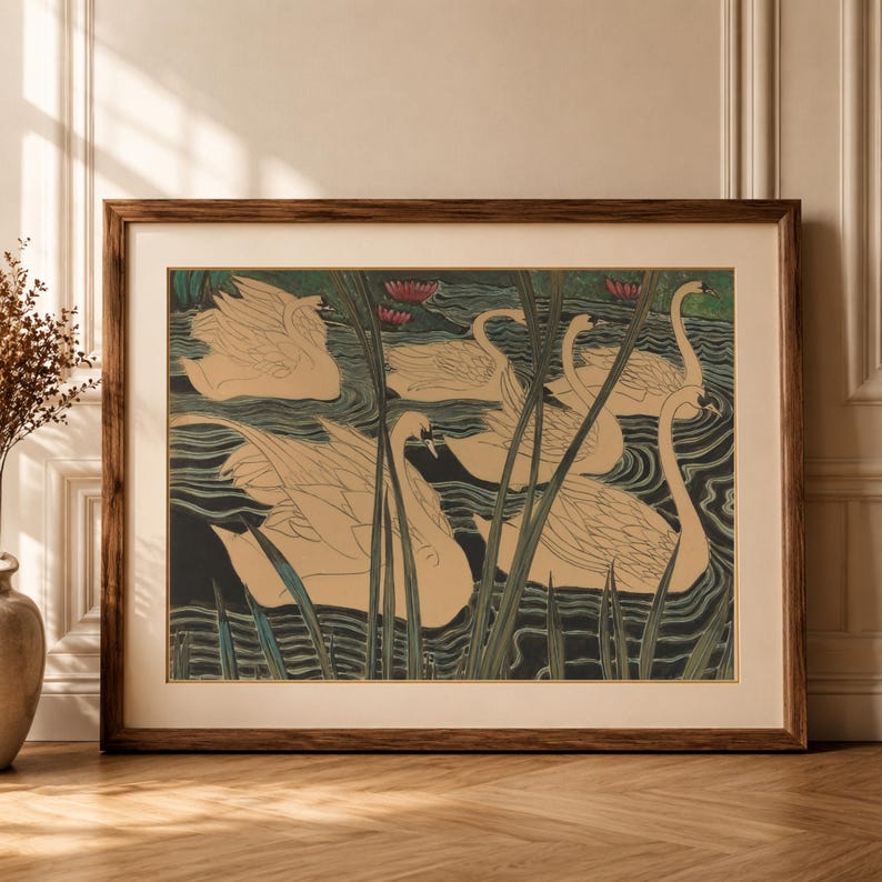May include: A framed art print featuring a stylized illustration of several beige swans swimming in dark, wavy water. Tall green reeds are positioned in the foreground, and small pink water lilies are visible in the background of the scene.