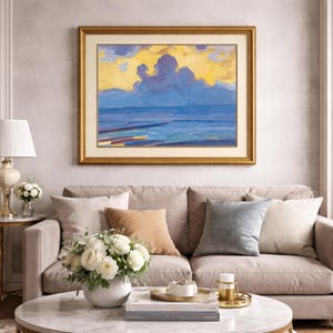 May include: A living room scene featuring a framed landscape painting with a gold frame, depicting a seascape with blue and yellow hues. A beige sofa with decorative pillows, a marble coffee table, and floral arrangements complete the decor.