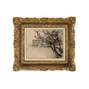 May include: A black and white etching of a building with trees in front of it, framed in a gold ornate frame.