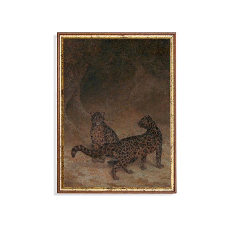 May include: A painting of two leopards in a dark cave setting. The leopards are brown and black with spots. The painting is framed in a gold frame.
