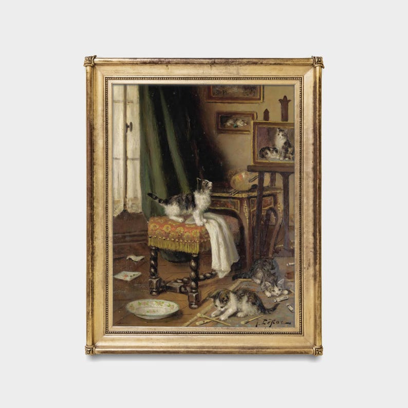 May include: A framed painting showing a domestic scene with kittens. One kitten stands on a small stool, while others play on the floor. The painting has a gold frame and features a window with green curtains.