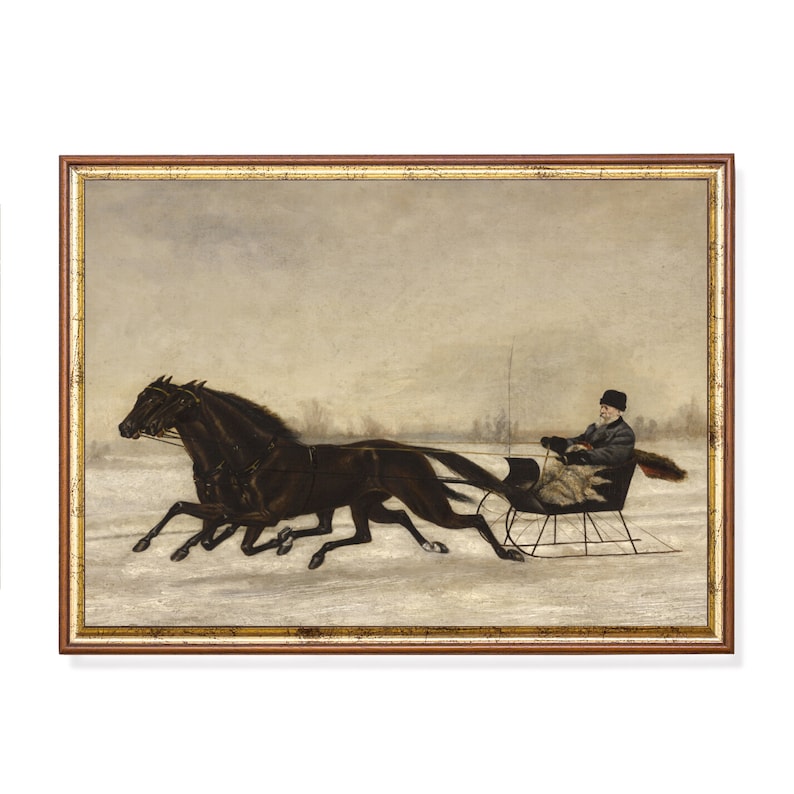 May include: Framed vintage print of a winter scene. Two dark horses pull a sleigh across a snowy landscape. A person in a black coat and hat sits in the sleigh. The frame is a warm brown color.