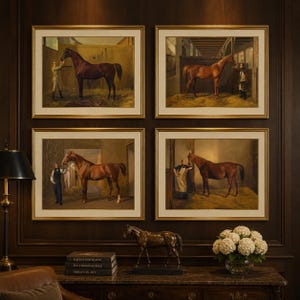 May include: A collection of four framed oil paintings depicting brown horses in stable settings with human figures, displayed above a dark wooden console table featuring a bronze horse sculpture, a stack of three books, and a glass vase of white flowers.