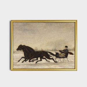 May include: A framed vintage print depicts a winter scene with two dark horses pulling a sleigh through the snow. A person is seated in the sleigh, bundled in warm clothing. The artwork is set against a muted, overcast sky.