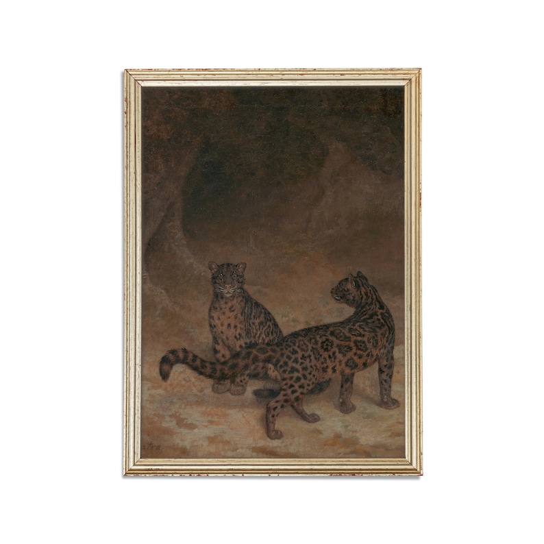 May include: A painting of two leopards in a dark cave setting. The leopards are brown and black with spots. The painting is framed in a gold frame.