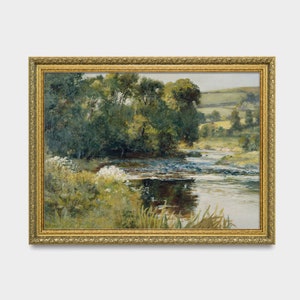 May include: A framed painting depicting a landscape scene with a river winding through a lush green forest. The river is calm and reflective, with a few small rapids. The forest is dense and full of trees, with a few patches of sunlight breaking through the canopy. The painting is in a gold frame.