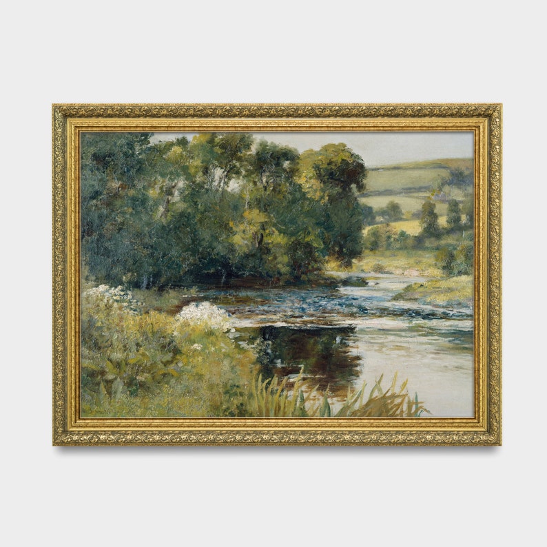 May include: A framed painting depicting a landscape scene with a river winding through a lush green forest. The river is calm and reflective, with a few small rapids. The forest is dense and full of trees, with a few patches of sunlight breaking through the canopy. The painting is in a gold frame.
