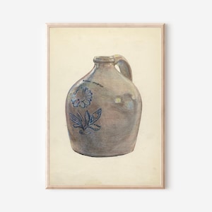 May include: A framed print of a stoneware jug with a handle. The jug is a muted brown color with a blue floral design on the front. The print has a vintage aesthetic and is set against a cream-colored background.