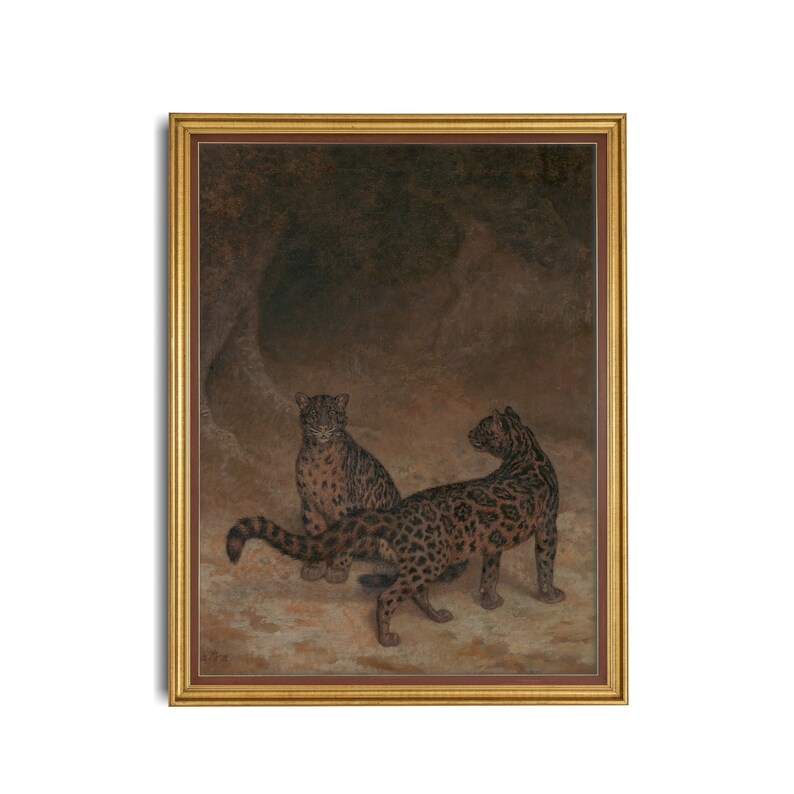 May include: A painting of two leopards in a dark cave setting. The leopards are brown and black with spots. The painting is framed in gold.