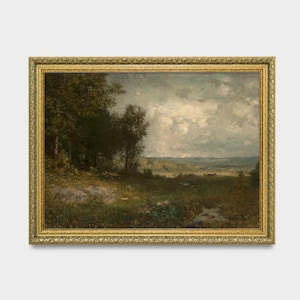 May include: A framed landscape painting depicting a rural scene with trees, a field, and a cloudy sky. The painting is in a gold frame with ornate details.