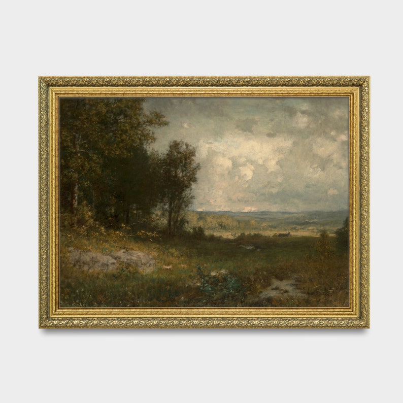 May include: A framed landscape painting depicting a rural scene with trees, a field, and a cloudy sky. The painting is in a gold frame with ornate details.