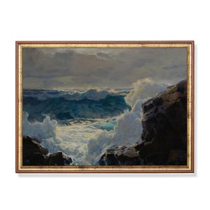 May include: A framed oil painting depicts a dramatic seascape. The artwork showcases crashing waves in shades of blue and white, contrasted by dark, rocky cliffs. The sky is overcast with gray clouds, enhancing the turbulent scene.