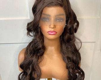 May include: A long, brown, wavy wig with a high ponytail. The wig is styled with loose curls and is worn on a mannequin head.