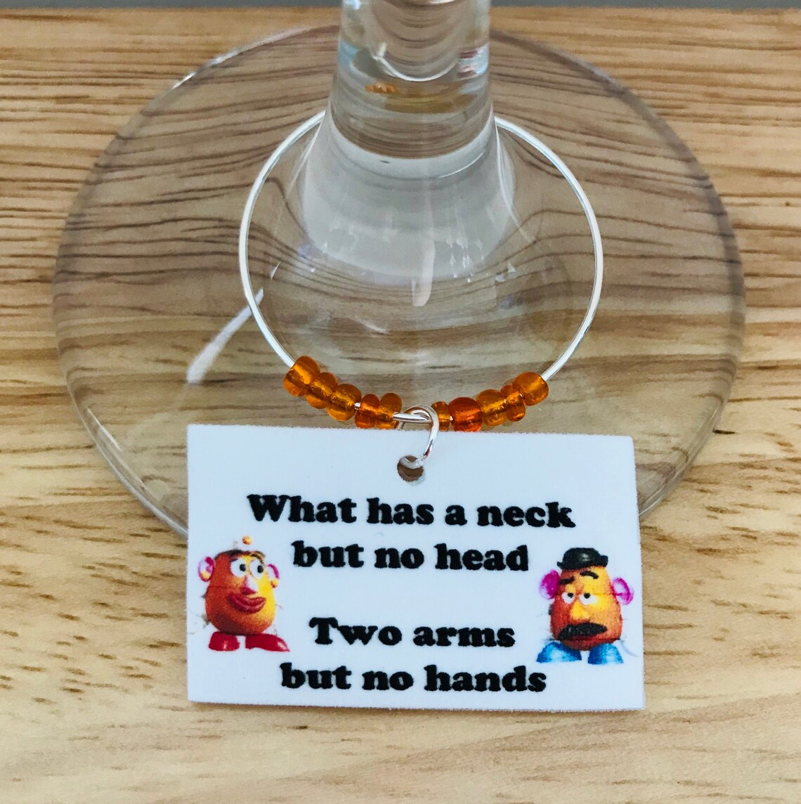 Riddle Wine Glass Charm What has a neck but no head Etsy