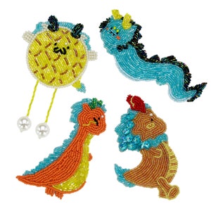 May include: Four beaded animal figures, a yellow and orange fish, a blue and black dragon, a blue and orange dinosaur, and a brown and blue dinosaur.