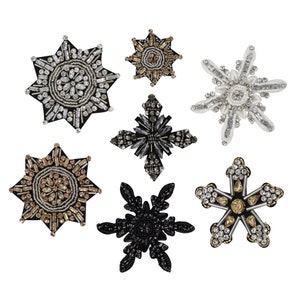 May include: Six snowflake-shaped embellishments with various colors and designs. The embellishments are made of beads and sequins. The embellishments are perfect for adding a touch of sparkle to any project.