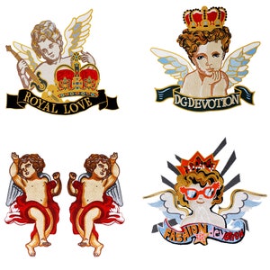 May include: Four embroidered iron-on patches featuring cherubs with wings. The patches have different designs, including a crown, a banner with the text "DG DEVOTION", a banner with the text "ROYAL LOVE", and a banner with the text "FASHION devotion".