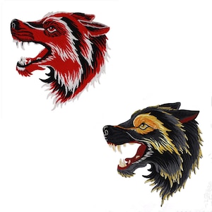 May include: Two embroidered iron-on patches of snarling wolf heads. One wolf is red and white, the other is black and gold.