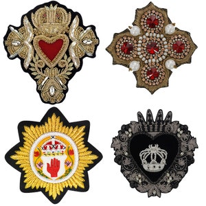 May include: Four embroidered iron-on patches with various designs. The first patch features a red heart with gold embellishments. The second patch is a gold cross with red and white jewels. The third patch is a gold star with a red hand and crown. The fourth patch is a black heart with a silver crown and jewels.