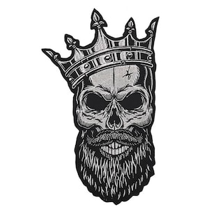 May include: Black and white embroidered patch of a skull wearing a silver crown and a long beard.