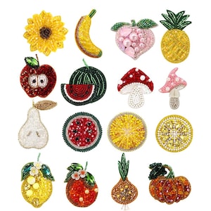 May include: A collection of sixteen decorative beaded patches featuring various fruits, vegetables, and mushrooms. The set includes a yellow sunflower, banana, peach, pineapple, red apple, watermelon slice, mushrooms, pear, citrus slices, lemon, orange, onion, and pumpkin.