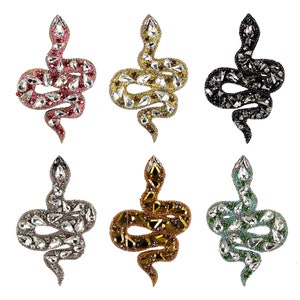 May include: Six rhinestone snake iron-on patches in different colours: pink, gold, black, silver, brown, and green.