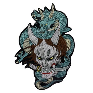 May include: Embroidered patch featuring a fierce, white-faced oni mask with horns, surrounded by a swirling blue dragon. The oni mask has sharp teeth and red eyes, while the dragon has a detailed, scaly design.