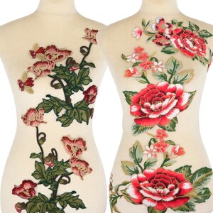 May include: Two floral embroidered appliques. One features a climbing vine with red and pink flowers, green leaves, and gold accents. The other has large red roses, smaller pink flowers, and green leaves, all on a sheer background.